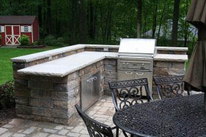 Backyard Oasis with Kitchen by Ryback Landscaping Patio with kitchen and grill