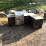 residential patio with an outdoor kitchen from Ryback Landscaping