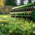 A vibrant green tool penetrates a flourishing lawn, creating glistening moisture in warm morning rays, with a soft-focus natural backdrop and faint tire markings.