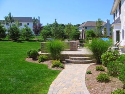 Picture of a yard with a patio and trees.